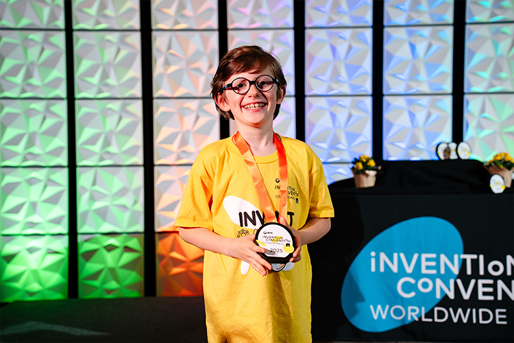 Oliver posing with an award